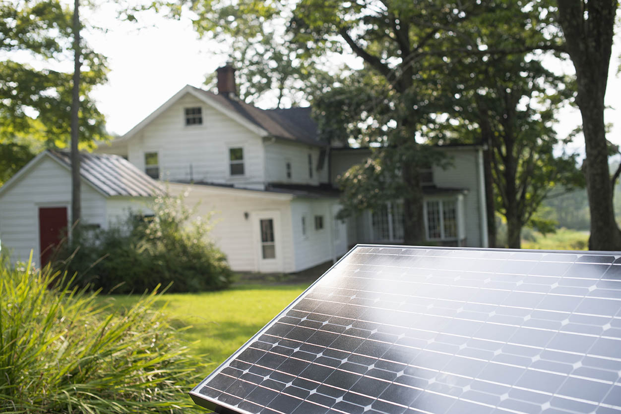Summer gathering,A solar panel in a farmhouse garden.
